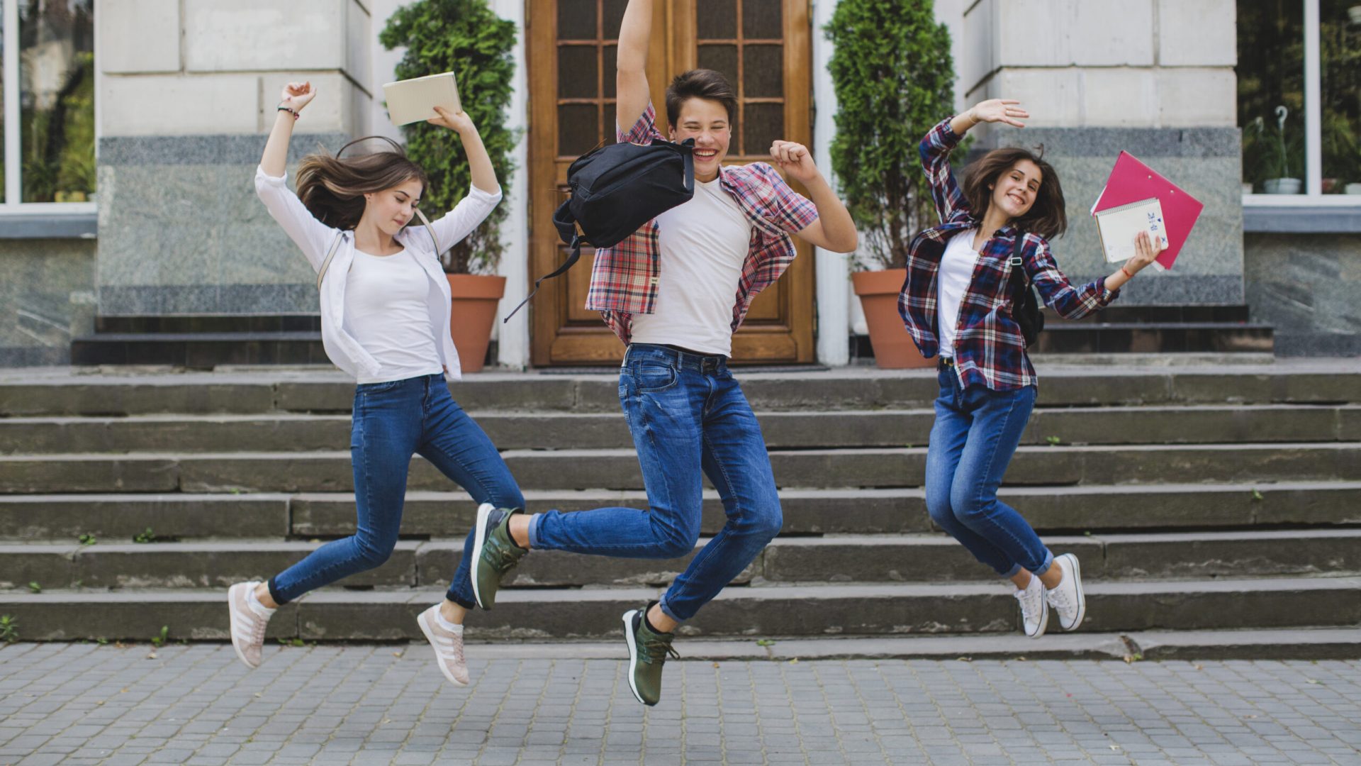 cheerful-students-jumping-excitement